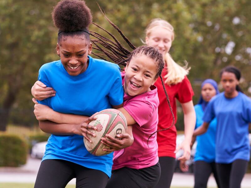 Girls playing tag rugby